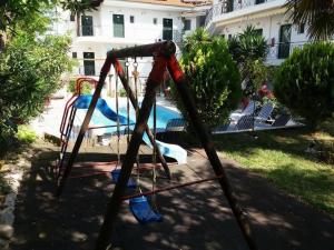 a swing set in front of a playground at Epic Studios Kallithea in Kallithea Halkidikis