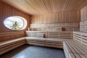 a sauna with wooden paneling and a circular window at The Standard Miami in Miami Beach