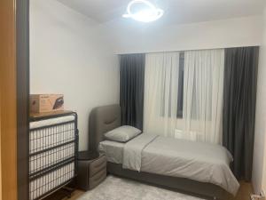 a bedroom with a bed and a large window at Luxury privet 3 bed room 1 saloon security Nearby vadi istanbul 10min to mall of Istanbul and city centre private spa & winter pool for women in Istanbul
