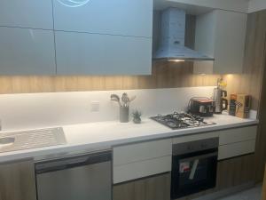 a kitchen with a stove top oven next to a sink at Luxury privet 3 bed room 1 saloon security Nearby vadi istanbul 10min to mall of Istanbul and city centre private spa & winter pool for women in Istanbul