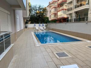 a swimming pool on the side of a building at Modern 2bedroom apt on Cleopatra (WiFi,pool) in Alanya