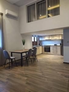 a kitchen and dining room with a table and chairs at Plumbago Apartment in Theológos