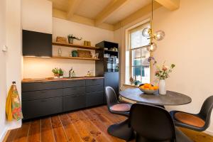 een keuken met een tafel en stoelen in een kamer bij Brinkzate - De Brink in Dwingeloo