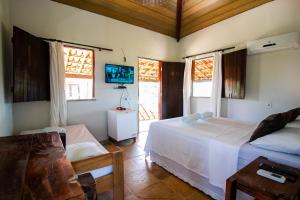 A bed or beds in a room at Pousada Brisamares