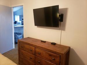 a bedroom with a dresser with a television on the wall at Multi Resorts at Eagles Nest in Branson