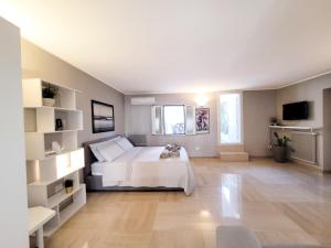 a bedroom with a white bed and white shelves at Luxury Penthouse in the heart of Bari with terrace in Bari