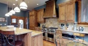 een keuken met houten kasten en een fornuis met oven bij 4 Bedroom Luxury Private Home In Vails Cascade Village With Mountain Views And Hot Tub in Vail
