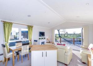 a kitchen and living room with a table and a couch at Ribble Valley View in Langho