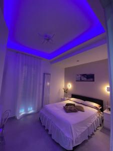 a bedroom with a bed with a purple ceiling at Mamuccia Rooms Posto Auto in Naples