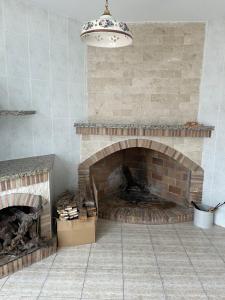 a room with a brick fireplace and a chandelier at Casa Almendro in Jumilla