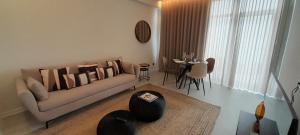 a living room with a couch and a table at Porto Covo Praia Hotel & SPA in Porto Covo