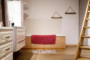 a kitchen with a red rug on the floor at L'hôtel de Police - Topdestination-Spa in Spa