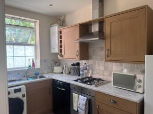 a kitchen with a sink and a stove top oven at Centrally Located Lincolnshire Home With Free Parking On Premises in Lincolnshire