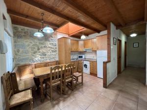 a kitchen with a wooden table and a dining room at Casa La Colmena Ávila in Avila