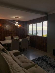 a living room with a couch and a table at APARTAMENTO ENCANTADOR NA BEIRA-MAR DE MACEIÓ in Maceió