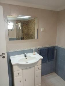 a bathroom with a white sink and a mirror at Casa do Poço in Quinta do Anjo +11 photos