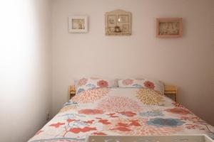 a bedroom with a bed with a comforter on it at L'hôtel de Police - Topdestination-Spa in Spa