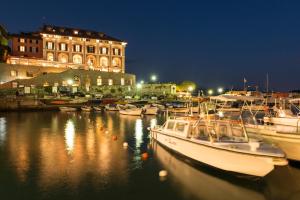 a group of boats docked in a marina at night at Grand Hotel Portovenere in Portovenere