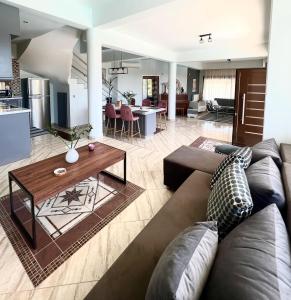 a living room with a couch and a table at Villa Kastro Elassona in Elassona +27 photos