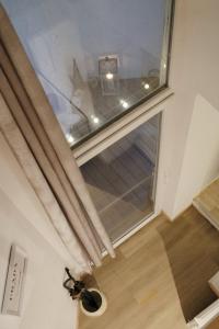 a butterfly is sitting on the floor next to a window at L'hôtel de Police - Topdestination-Spa in Spa +2 photos