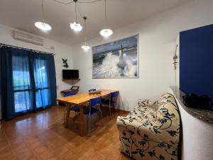 a living room with a table and a couch at Casa Betta in Stintino