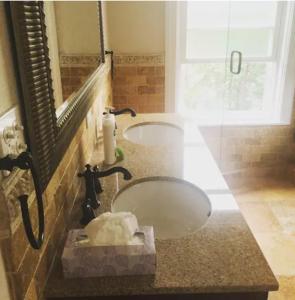 a bathroom with a sink and a mirror at Large Suite w/ Private Bath,great location in Boston +16 photos