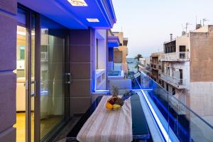 a bowl of fruit on a table on a balcony at Ma President Suite, DeMaNi President Suites in Sitia