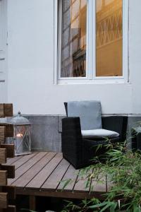 a chair sitting on a wooden table in front of a window at L'hôtel de Police - Topdestination-Spa in Spa