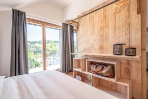 a bedroom with a bed and a large window at stuub todtnauberg in Todtnauberg