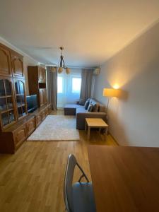 a living room with a couch and a table at Sunrise Apartment in Constanţa