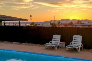 two chairs and a table next to a swimming pool at 4 Mi to Beach Lake Havasu Apartment with Pool! in Lake Havasu City