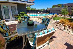 a glass table and chairs on a patio at 4 Mi to Beach Lake Havasu Apartment with Pool! in Lake Havasu City