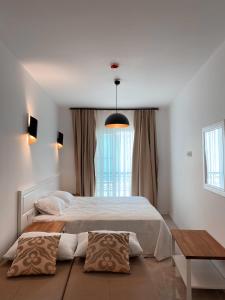 A bed or beds in a room at Amber Boutique Hotel
