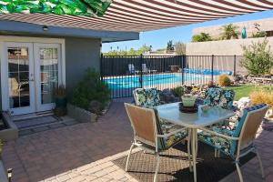 a patio with a table and chairs and a pool at 4 Mi to Beach Lake Havasu Apartment with Pool! in Lake Havasu City