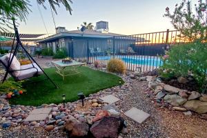 a backyard with a swing and a yard with a pool at 4 Mi to Beach Lake Havasu Apartment with Pool! in Lake Havasu City