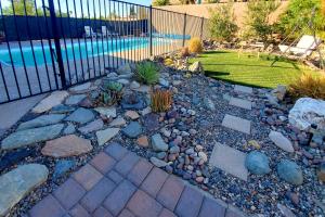 a garden with rocks and a fence and a pool at 4 Mi to Beach Lake Havasu Apartment with Pool! in Lake Havasu City
