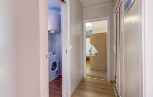 a hallway with a washing machine in a room at Kuća s jacuzzijem Mavrinac in Nerezine