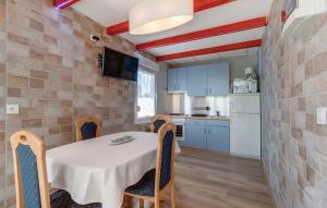 a kitchen and dining room with a table and chairs at Kuća s jacuzzijem Mavrinac in Nerezine