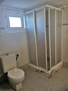 a bathroom with a toilet and a shower at Evangelias House! in Stavros +5 photos