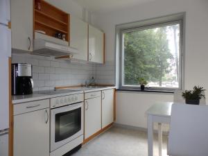 a kitchen with white appliances and a window at Vestergade 7 Holiday Apartments in Frederikshavn