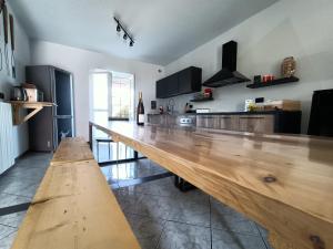 a large wooden bar in a kitchen with a counter at MarMolí in Villanova dʼAsti