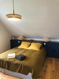ein Schlafzimmer mit einem großen Bett mit gelben Kissen in der Unterkunft Chambre privée Luz in Luz-Saint-Sauveur