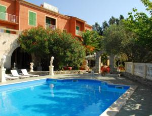 a swimming pool in front of a building at Castellu Rossu in Lucciana
