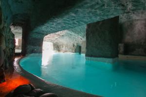 a large swimming pool in a cave with blue water at Grand Hotel Santa Domitilla in Ponza