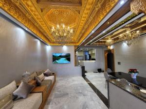 a living room with a gold ceiling and a couch at ZR Comfort Delux in Fez
