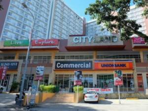 a car is parked in front of a city building at TAGAYTAY PRIME RESIDENCES Big Group AMAZING HOMES unit2038-reach by viber in Tagaytay