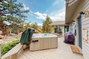 a hot tub on a deck next to a house at Elk Ridge Retreat #3098 in Estes Park