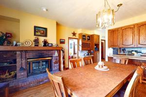 a kitchen with a dining table and a fireplace at Elk Ridge Retreat #3098 in Estes Park