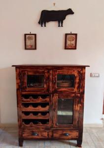 a wooden cabinet with a cow on the wall at Eco House San Michele in San Michele