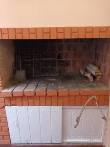 a fireplace made out of brick at Casa céntrica premium in San Pedro +7 photos